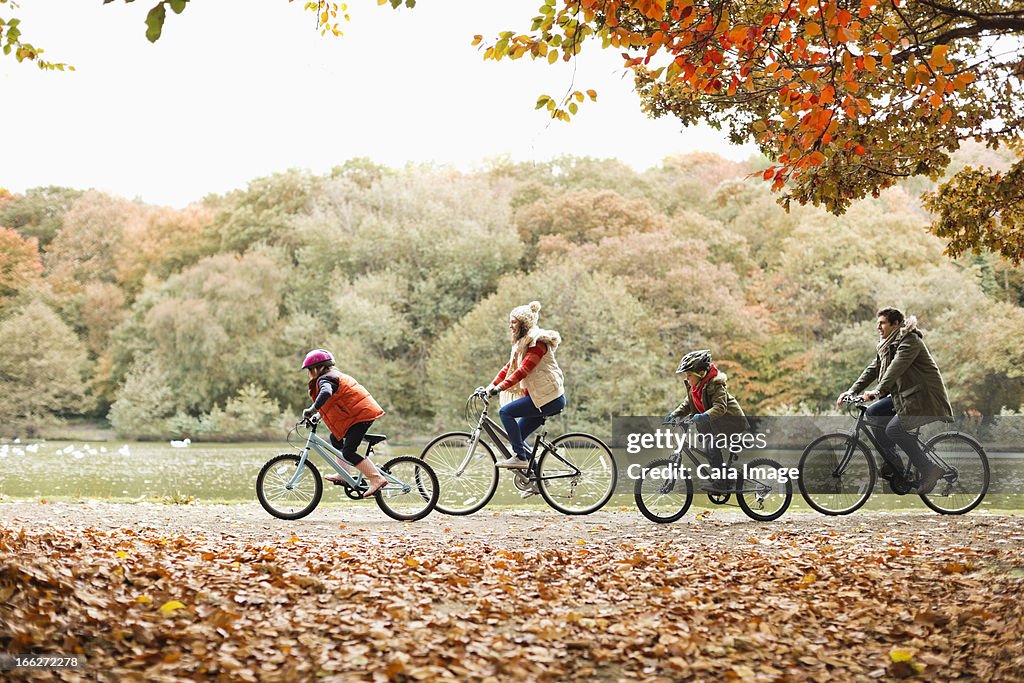 Family riding bicycles together in park