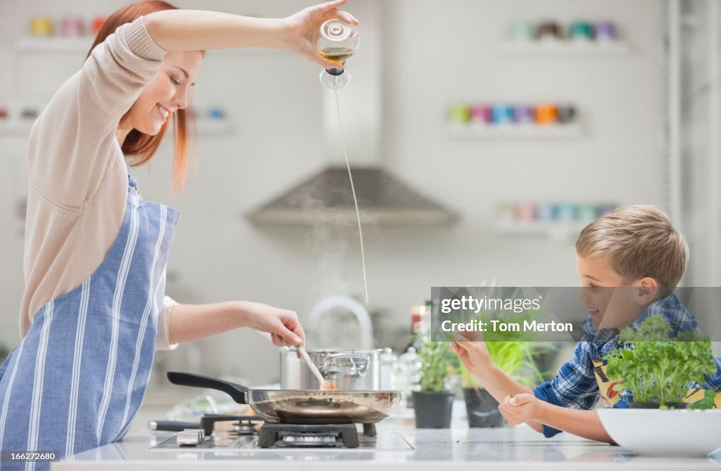 Mother and son cooking in kitchen