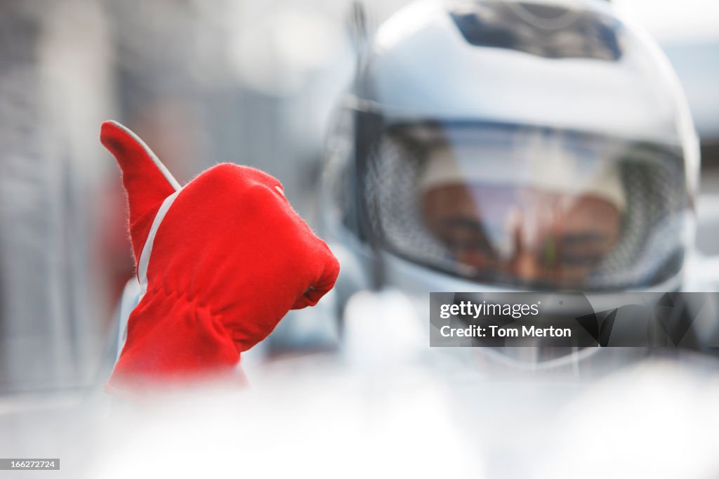 Racer giving thumbs up in car