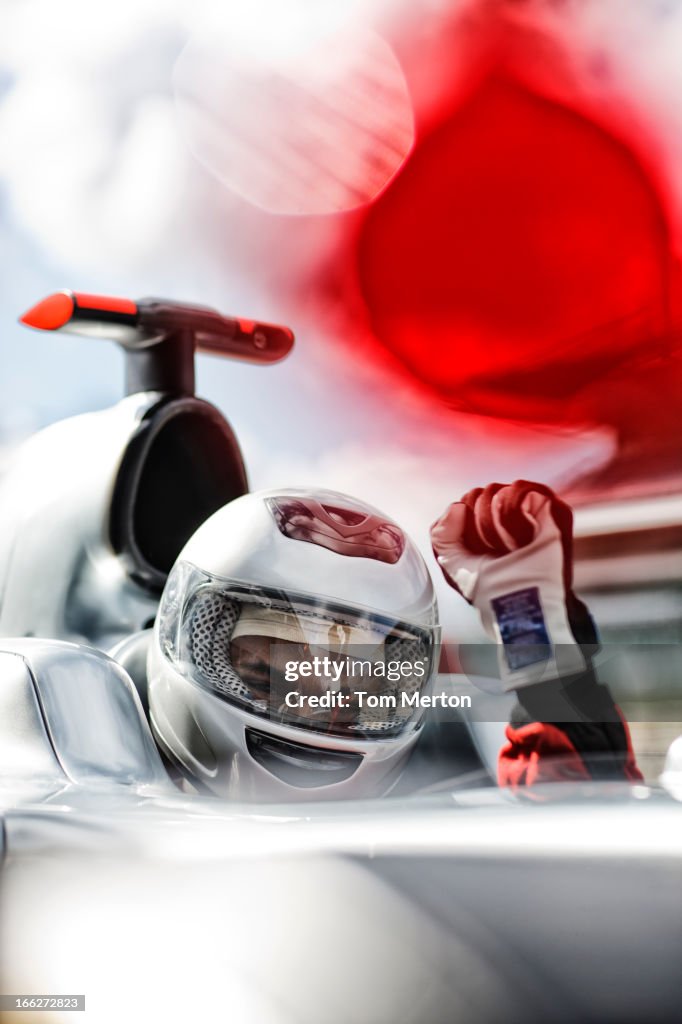 Racer cheering in car on track