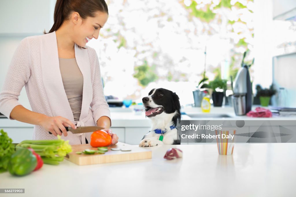 Woman chopping vegetables in kitchen