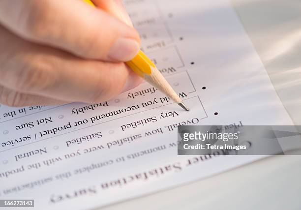 close-up of hand filling out form - human body part stock pictures, royalty-free photos & images