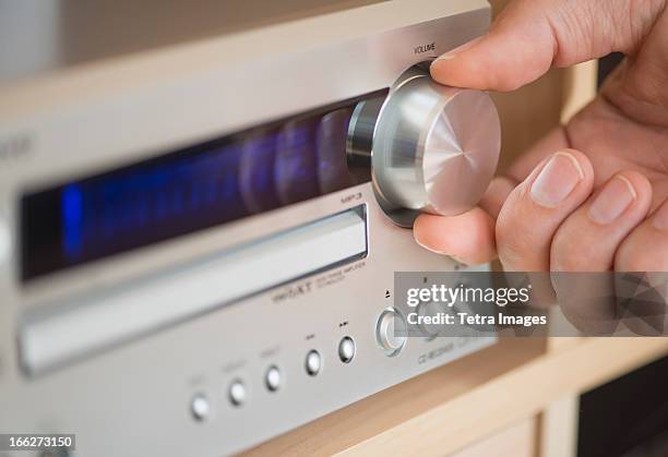 usa, new jersey, jersey city, close-up of hand adjusting audio system - stereo fotografías e imágenes de stock