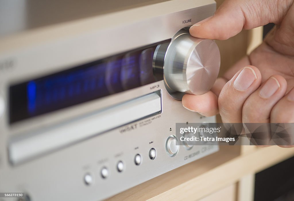 USA, New Jersey, Jersey City, Close-up of hand adjusting audio system