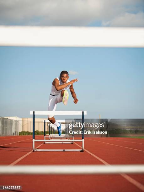 usa, california, fontana, boy (12-13) hurdling on running track - hurdle stock pictures, royalty-free photos & images