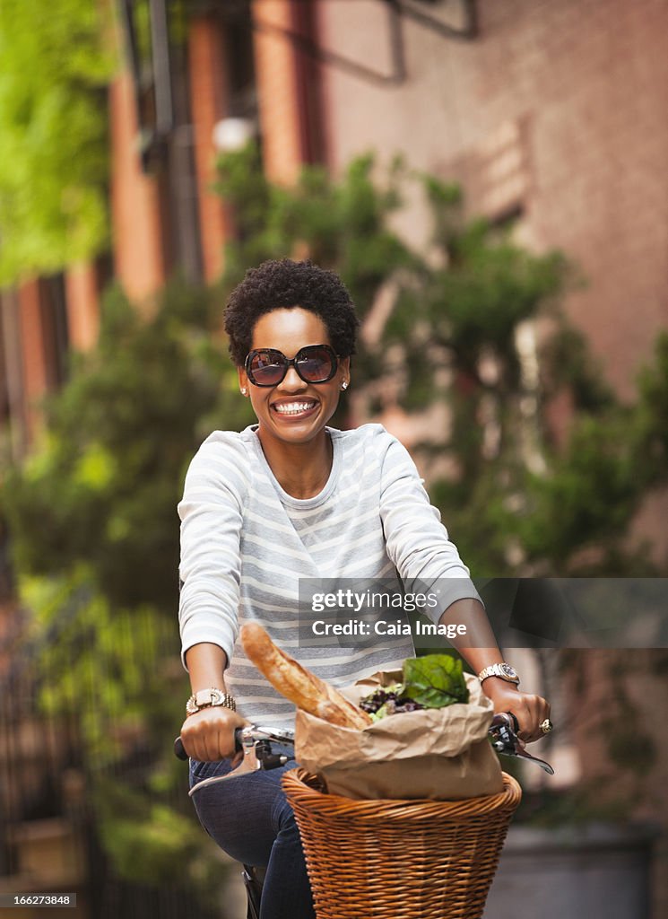 Woman riding bicycle on city street