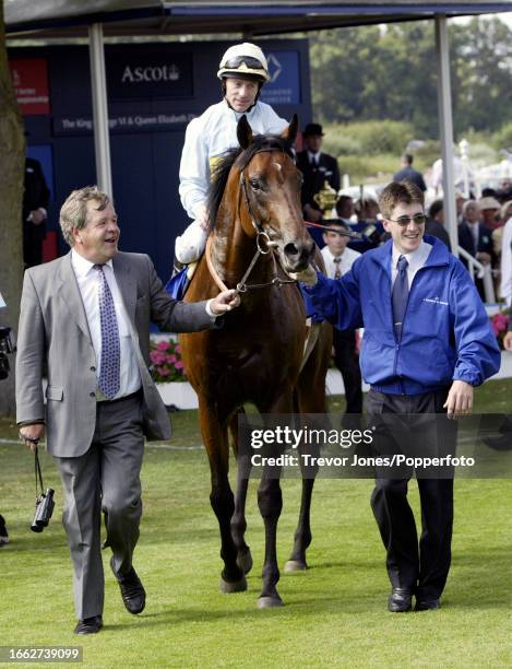 Irish Jockey Kieren Fallon riding Golan led in by Trainer Sir Michael Stoute after winning the King George VI and Queen Elizabeth Diamond Stakes at...