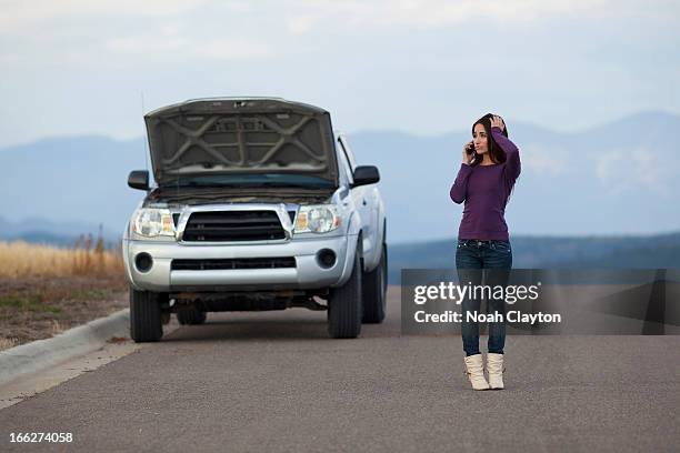 usa, montana, whitefish, woman calling for assistance after vehicle breakdown - car boken stock pictures, royalty-free photos & images