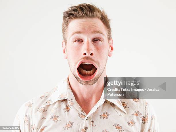 studio shot of man with windblown mouth - lelijkheid stockfoto's en -beelden