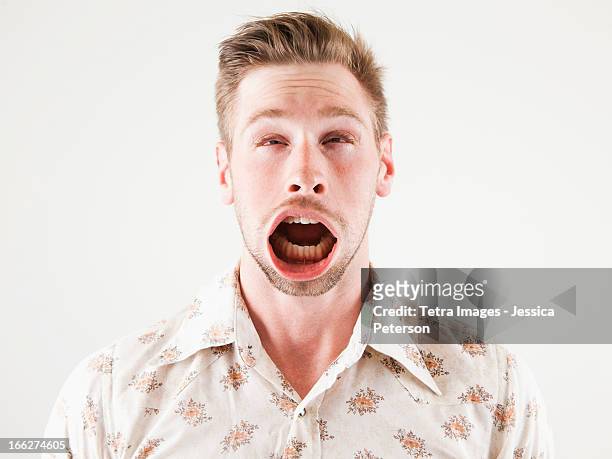 studio shot of man with windblown mouth - ugly people stock pictures, royalty-free photos & images