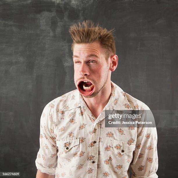 studio shot of man with windblown mouth - man open mouth stock pictures, royalty-free photos & images