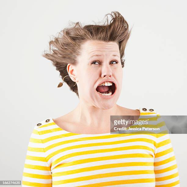 studio shot of woman with windblown mouth - ugly woman stock pictures, royalty-free photos & images