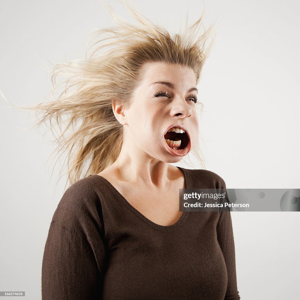 Studio shot of woman with windblown mouth