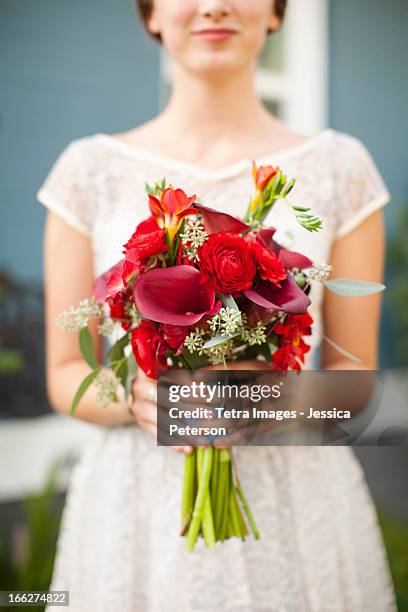 usa, utah, provo, mid section of bride with bouquet in focus - utah wedding stock pictures, royalty-free photos & images