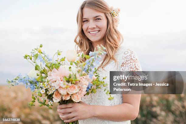 usa, utah, provo, portrait of bride holding bunch of flowers - utah wedding stock pictures, royalty-free photos & images