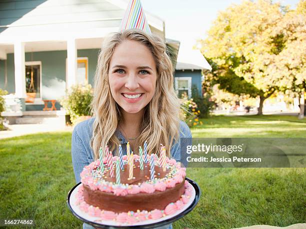 usa, utah, provo, portrait of young woman holding birthday cake - holding birthday cake stock pictures, royalty-free photos & images