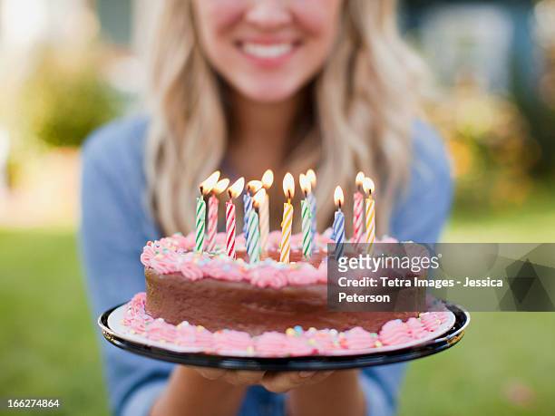 usa, utah, provo, mid-section of young woman holding birthday cake - birthday cake stock pictures, royalty-free photos & images
