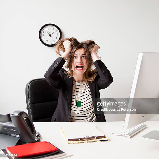 studio shot of young woman working in office and tearing her hair out - clock person desk stock pictures, royalty-free photos & images