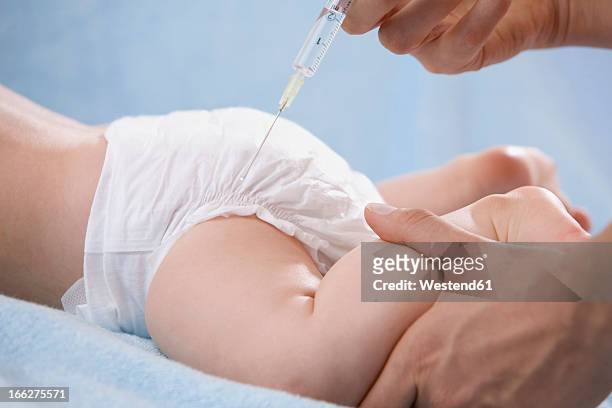 female doctor injecting baby, close-up - baby vaccination stock pictures, royalty-free photos & images