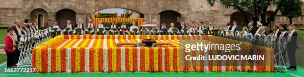 India's Prime Minister Narendra Modi along with world leaders pay respect at the Mahatma Gandhi memorial at Raj Ghat on the sidelines of the G20...