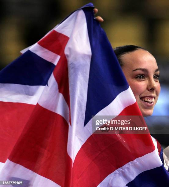 Elizabeth Tweddle of Great Britain holds a Union Jack during the medal ceremony after performing on the uneven bars in the women's apparatus final in...