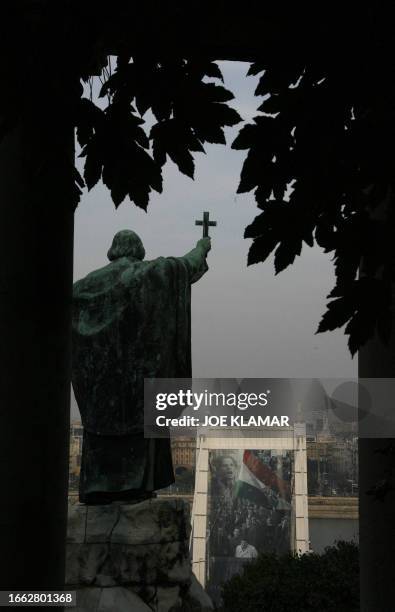 Statue of bischop Gellert overlooks Elisabeth bridge displaying a giant banner, showing the Hungarian uprising in 1956, in Budapest 22 October 2006....