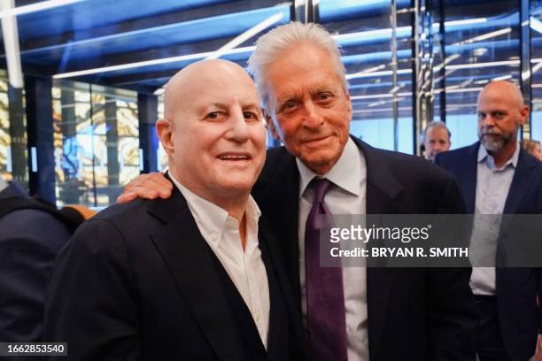 Businessman Ron Perelman and actor Michael Douglas pose for a photograph during the ribbon cutting ceremony for the Perelman Performing Arts Center...
