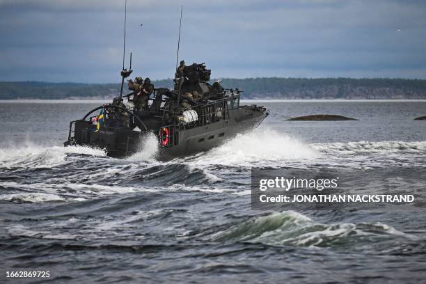 Soldiers from the Swedish Amphibious Corps and the US Marine Corps ride on the CB90-class fast assault craft, as they participate in military...