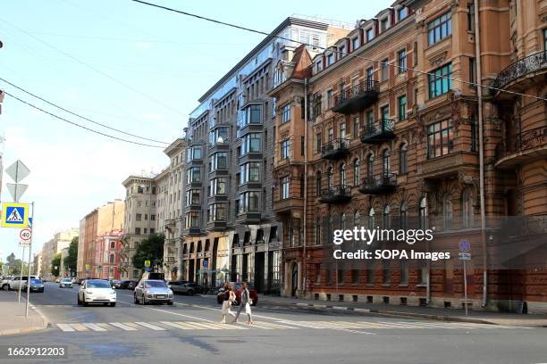 Pedestrians seen crossing the road in Tverskaya Street in the center of Saint Petersburg.