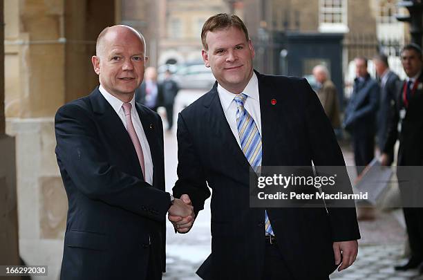 British foreign Secretary William Hague greets Canadian Foreign Affairs Minister John Baird at the G8 Foreign Ministers meeting at Lancaster House on...