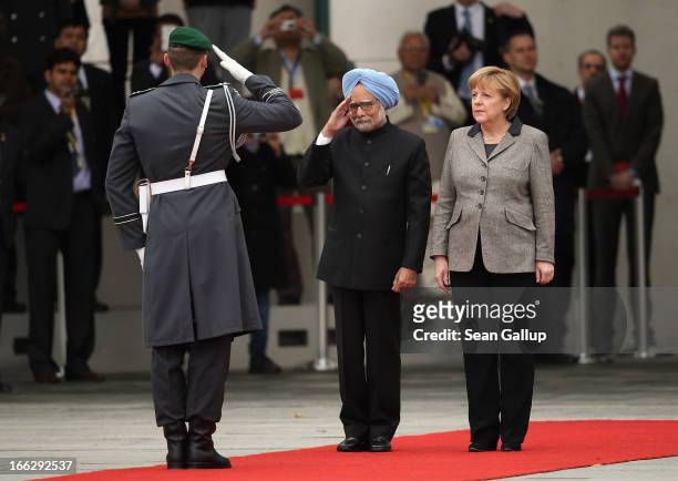 German Chancellor Angela Merkel and Indian Prime Minister Manmohan Singh finish reviewing a guard of honour upon Singh's arrival at the Chancellery...