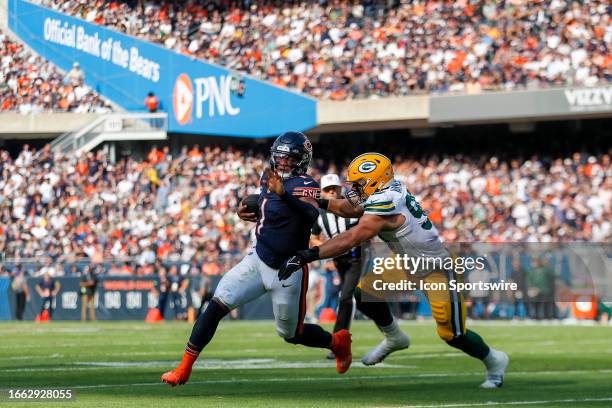 Chicago Bears quarterback Justin Fields scrambles in front of Green Bay Packers linebacker Lukas Van Ness in the first half during a regular season...