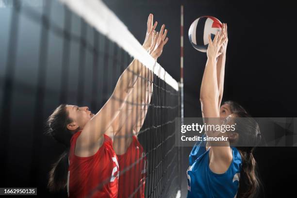 female volleyball players playing volleyball - volleying stock pictures, royalty-free photos & images