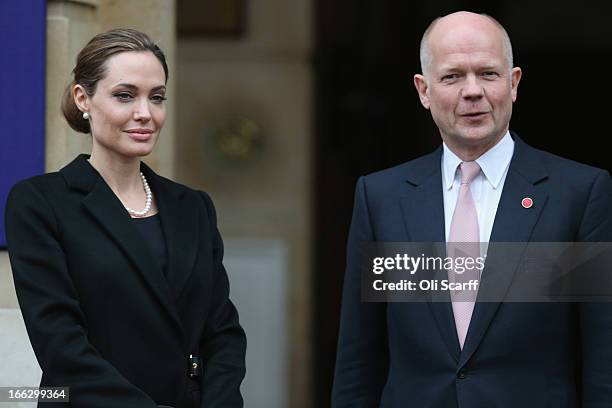 Actress Angelina Jolie is greeted by British Foreign Secretary William Hague at Lancaster House before attending the G8 Foreign Ministers' conference...