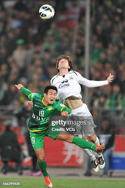 Oleg Zoteev of Bunyodkor and Wang Xiaolong of Beijing Guoan battle for the ball during the AFC Champions League Group match between Beijing Guoan and...