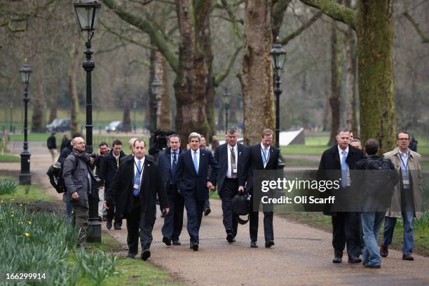 Secretary of State John Kerry walks through Green Park with colleagues and security on April 11, 2013 in London, England. G8 Foreign Ministers are...