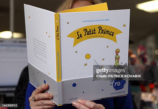 Woman reads a new edition of "The Little Prince" book on April 11, 2013 in Paris. France is marking the 70th anniversary of the world-loved "The...