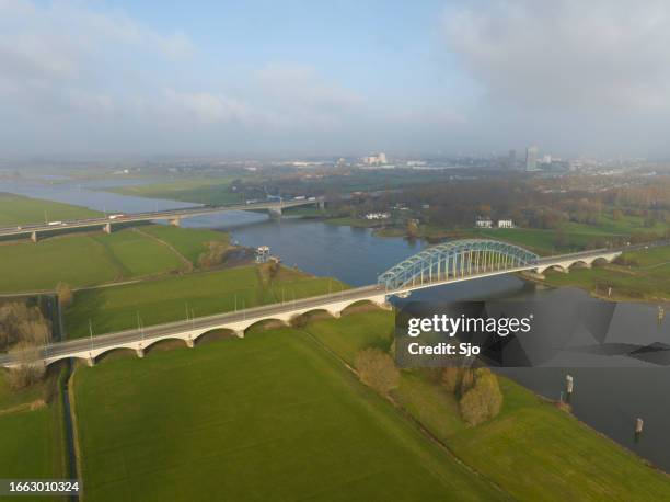 ijsselbrug bridge over the river ijssel from above - overijssel stockfoto's en -beelden