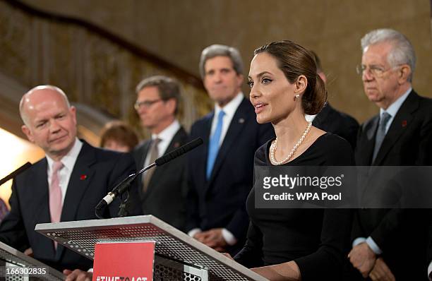 Actress Angelina Jolie in her role as UN envoy, talks during a news conference regarding sexual violence against women in conflict, as British...