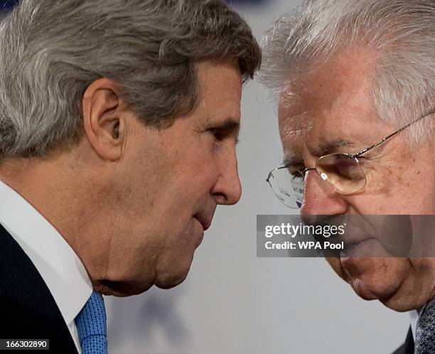 Secretary of State John Kerry speaks to Italian Prime Minister Mario Monti as they wait for a G8 Foreign Ministers press conference on sexual...