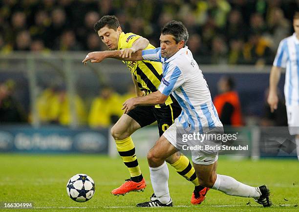 Jeremy Toulalan of Malaga and Robert Lewandowski of Borussia Dortmund fight for the ball during the UEFA Champions League quarter-final second leg...