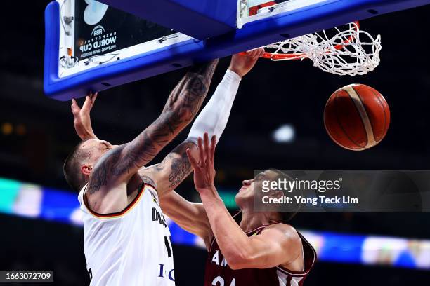 Daniel Theis of Germany dunks the ball against Andrejs Grazulis of Latvia in the third quarter during the FIBA Basketball World Cup quarterfinal game...