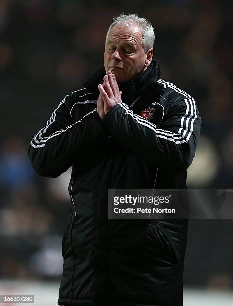 Swindon Town manager Kevin MacDonald appears to pray during the npower League One match between MK Dons and Swindon Town at stadium:mk on April 9,...