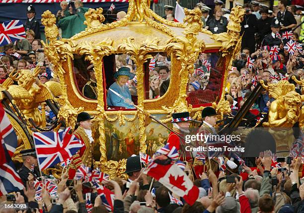 Britain's Queen Elizabeth and Prince Philip ride in the Golden State Carriage at the head of a parade from Buckingham Palace to St Paul's Cathedral...