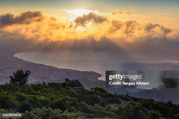 scenic sunrise above small city by the sea - aegean sea stock pictures, royalty-free photos & images