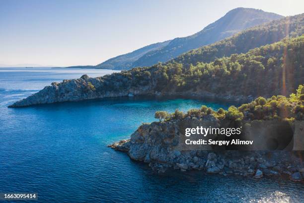 sunny scenery of blue lagoons and steep mountains in mediterranean basin of turkey - marmaris stock-fotos und bilder