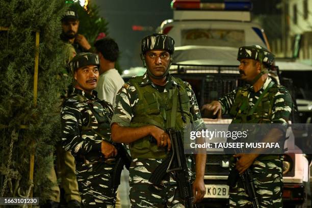 Indian security personnel stand guard outside a police headquarter in Srinagar on September 13 during a wreath laying ceremony for the police officer...