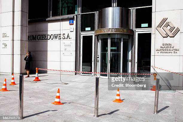 Cones and tape cordon an area outside the entrance to the Warsaw Stock Exchange during exterior cleaning work in Warsaw, Poland, on Thursday, April...