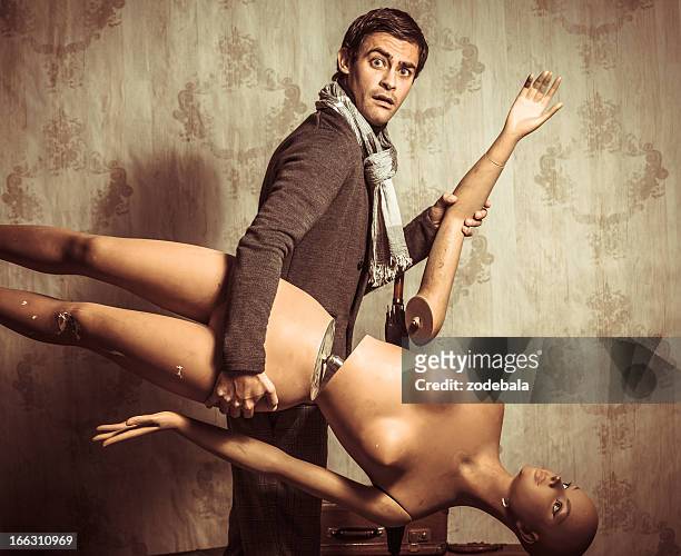 bizzarre retro man with broken mannequin - mannequin arm stock pictures, royalty-free photos & images