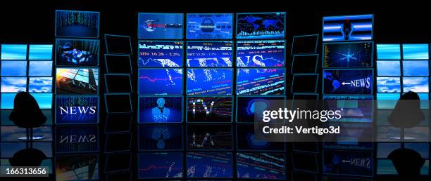 multiple tv screens display news in a dark studio - tv on wall stockfoto's en -beelden